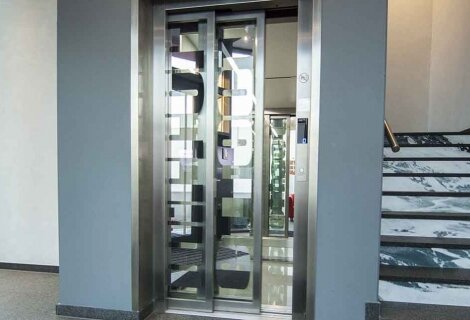 Elevator doors adorned with signage vinyl, displaying important information or promotional messages, adding visual interest and functionality to the space.